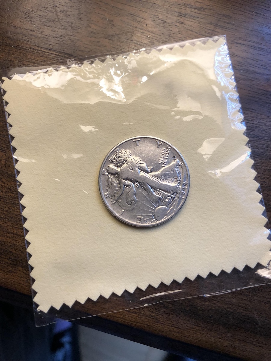 A Walking Liberty half dollar on a silver polishing cloth